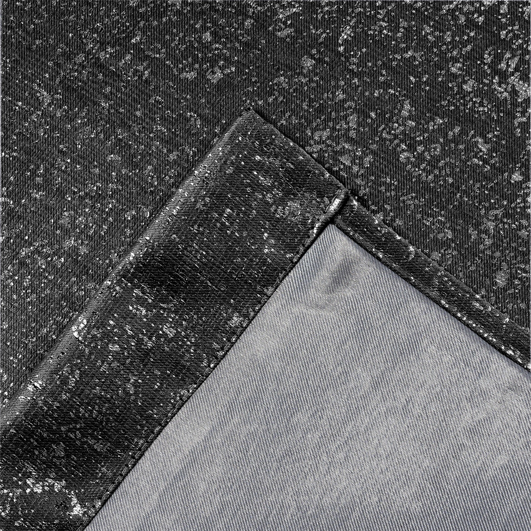 Close-up of black lurex textured curtain fabric with a diagonal seam