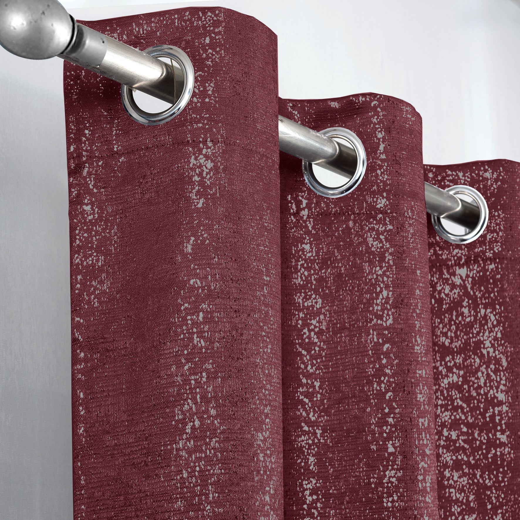 Burgundy Glittery curtain with silver grommets on a gray background